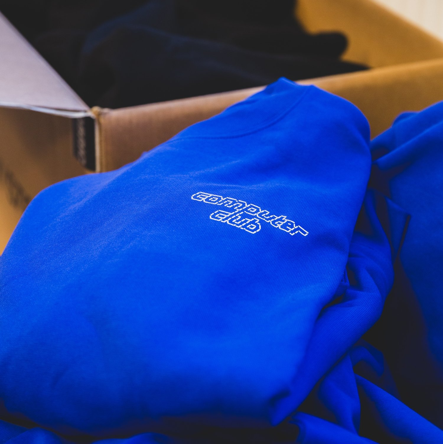 A blue sweat with a Computer Club logo.